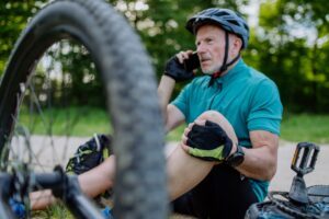 A man talking to his insurance company about bicycle accident settlement amounts. 