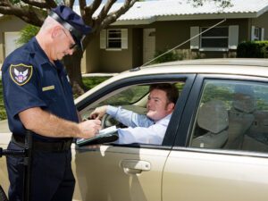A man talking to a police officer after an accident for an article explaining if you can claim a car accident without a police report. 