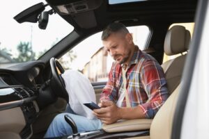 A man on his phone after a crash, wondering what to do after a car accident that’s not your fault in WA.